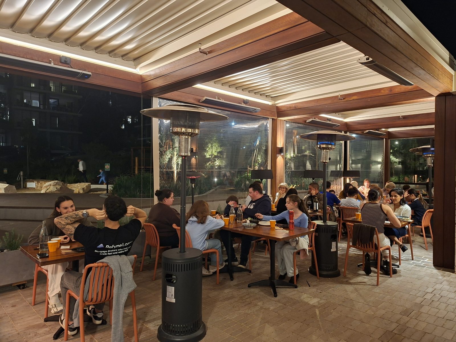 The covered terrace, warmed and open into the evening