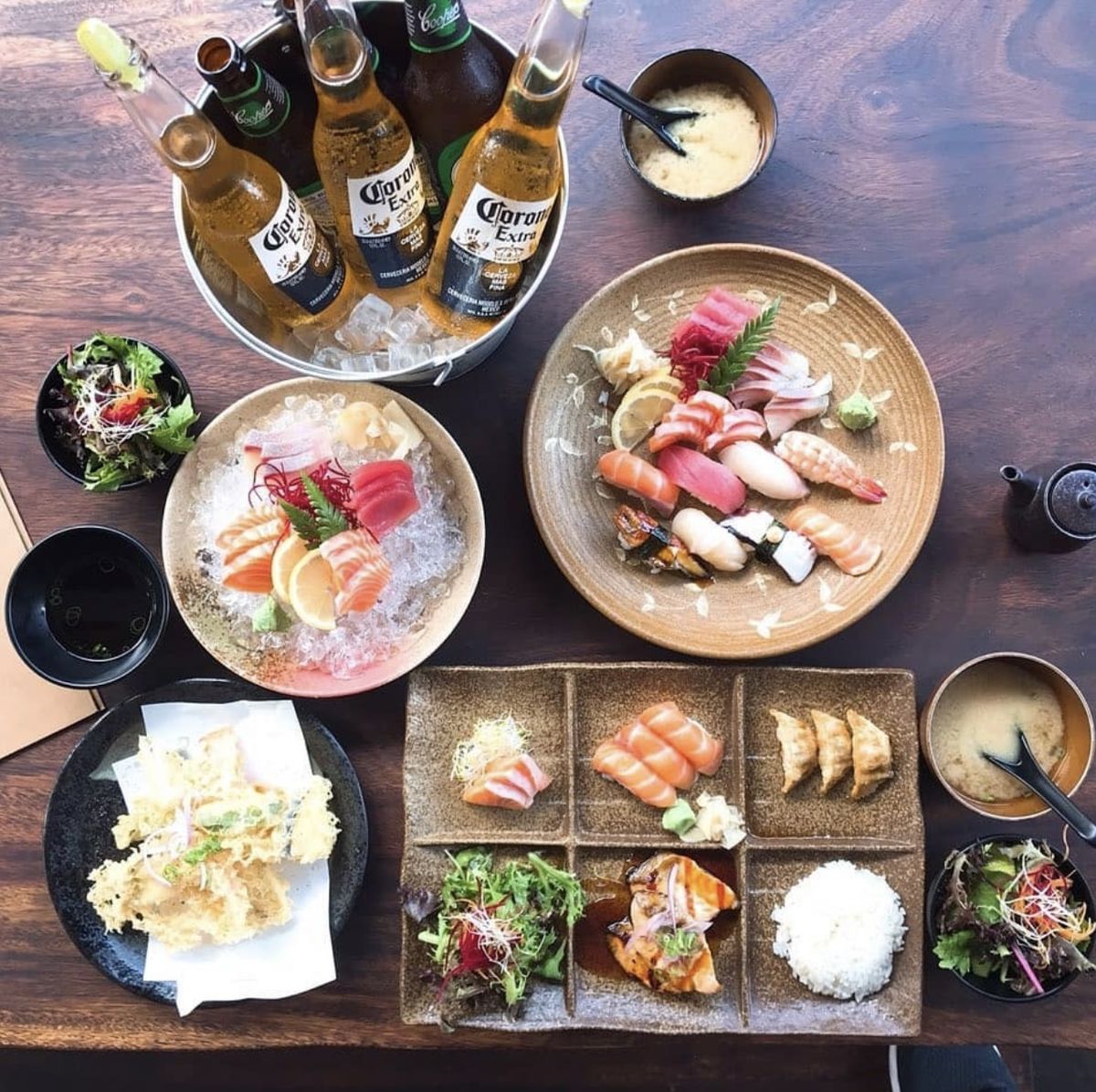 A table of sashimi, nigiri, bento and tempura